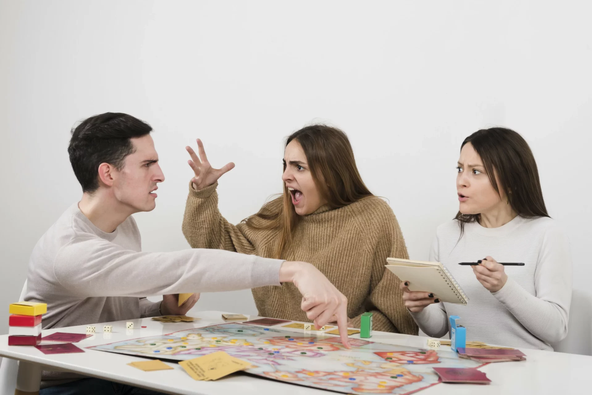 Three people argue over bad user instructions for a board game
